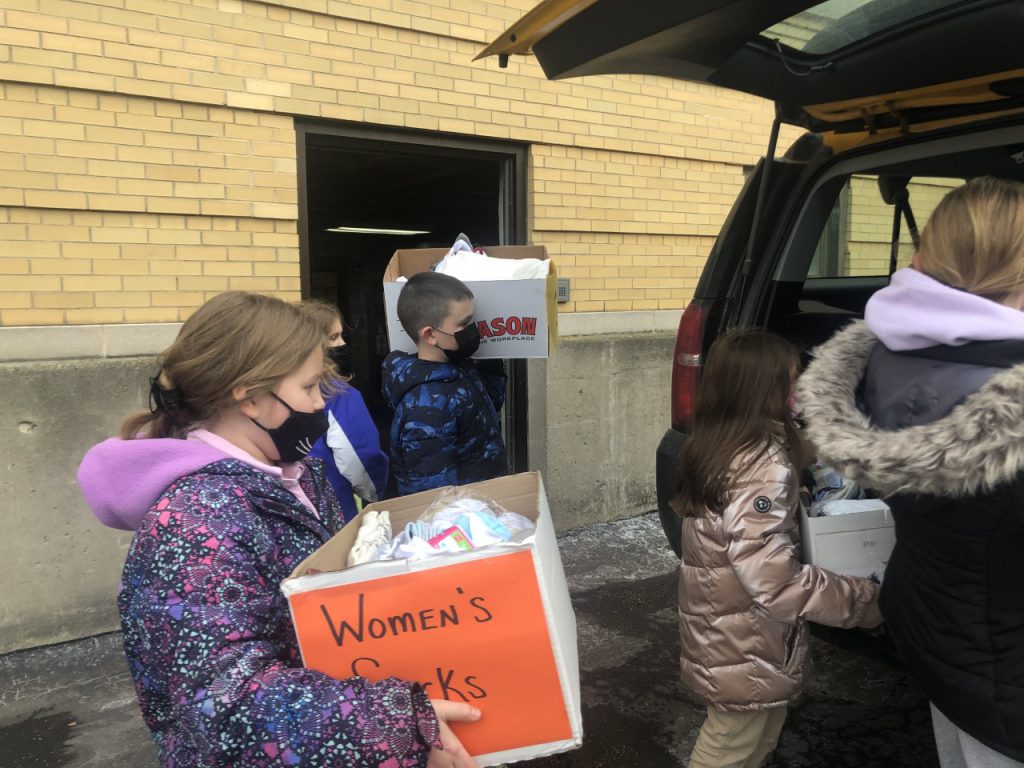 ESGO students load up donated socks to deliver to the Auburn Rescue Mission